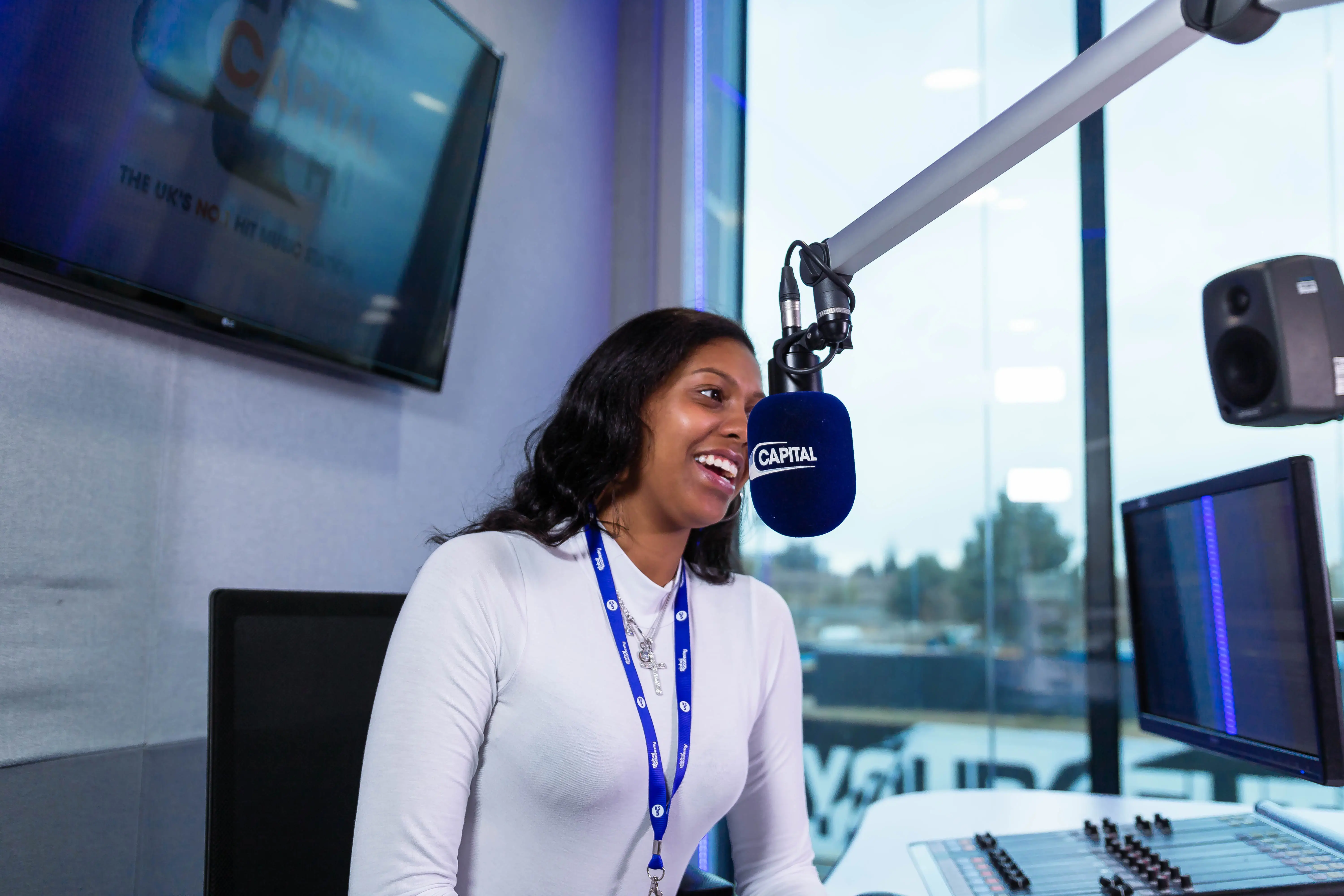 Presenter speaking on air at a radio station microphone