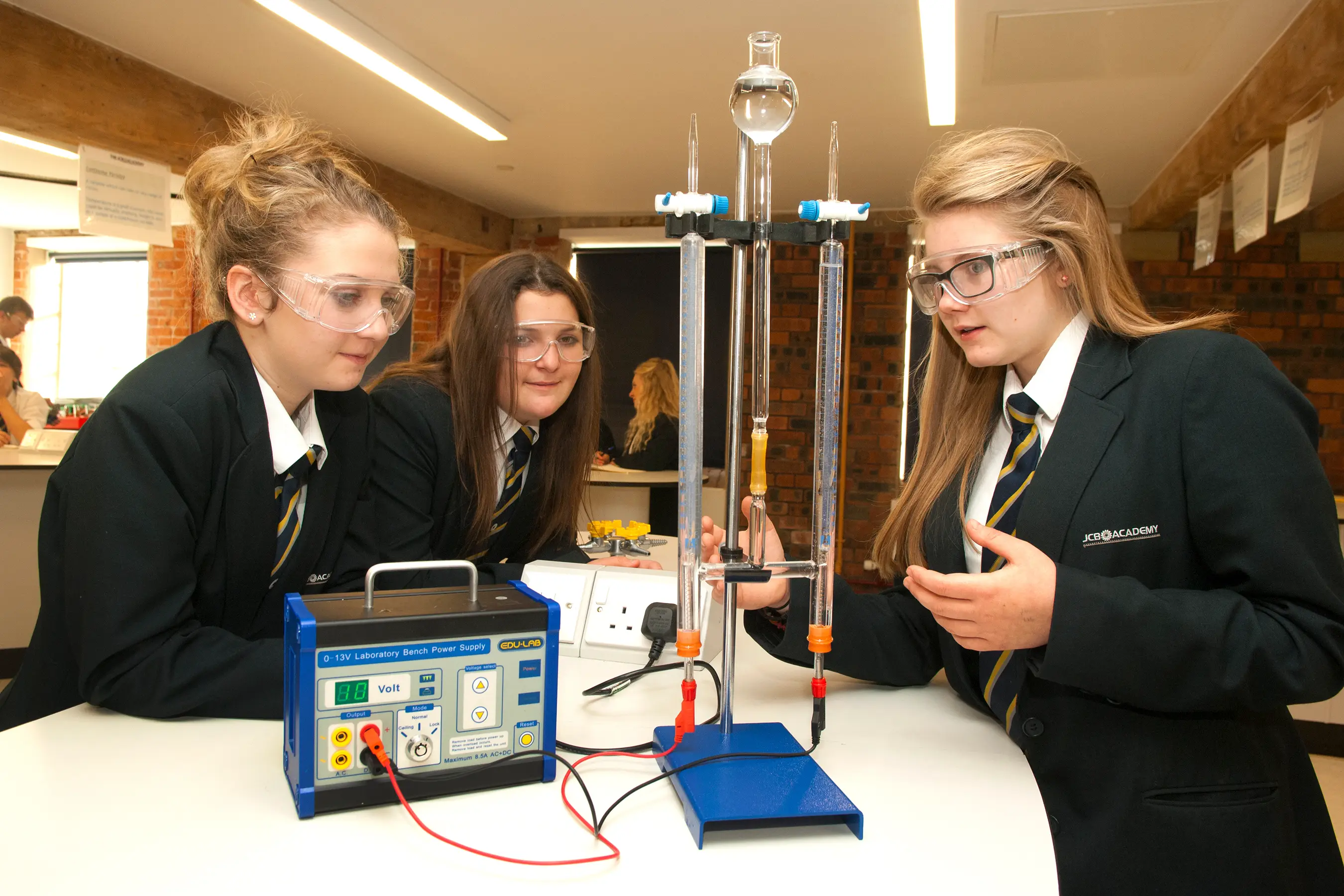 Students in school uniform conducting a chemistry experiment