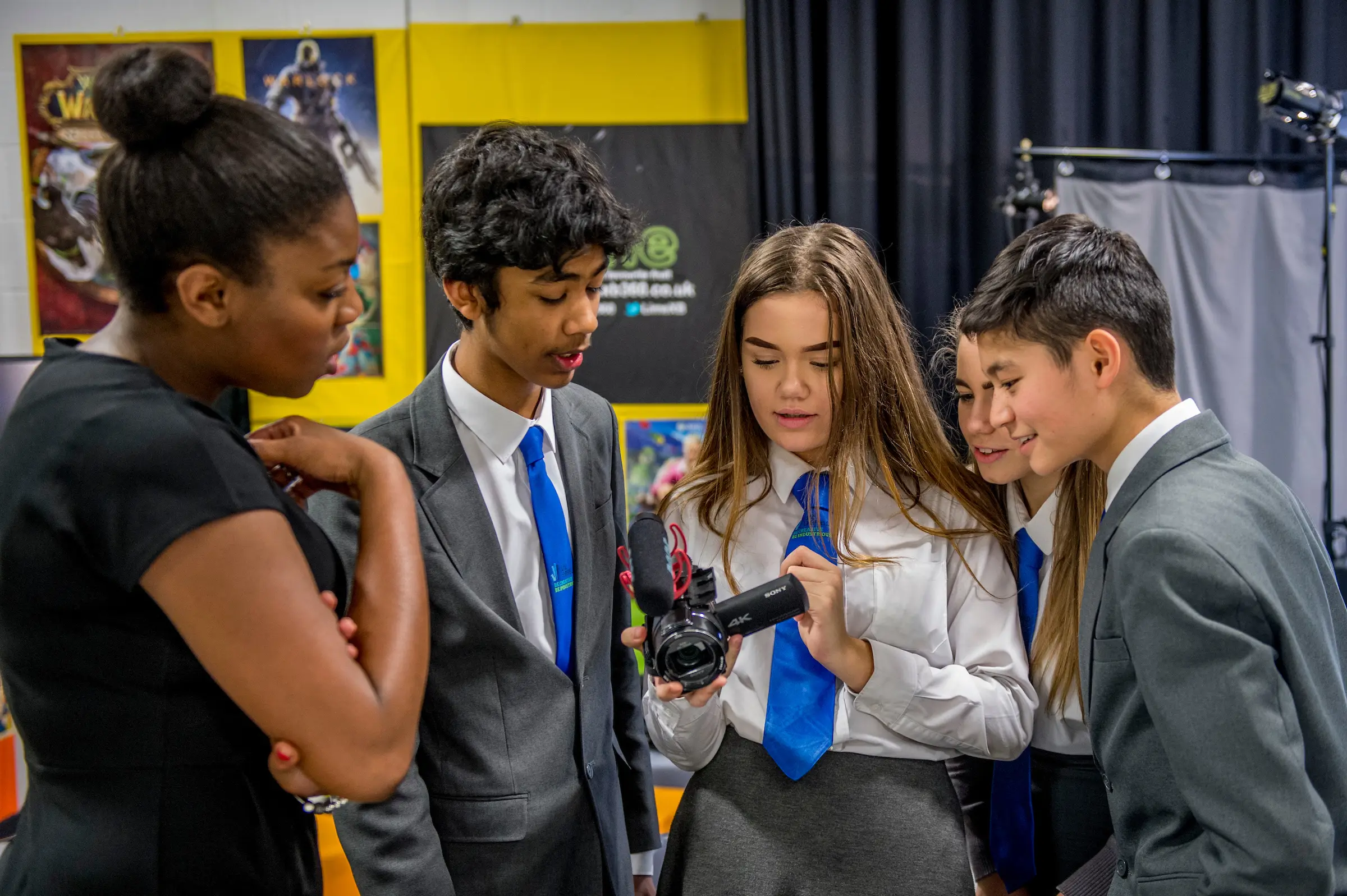 Students filming with a video camera in a technical education studio