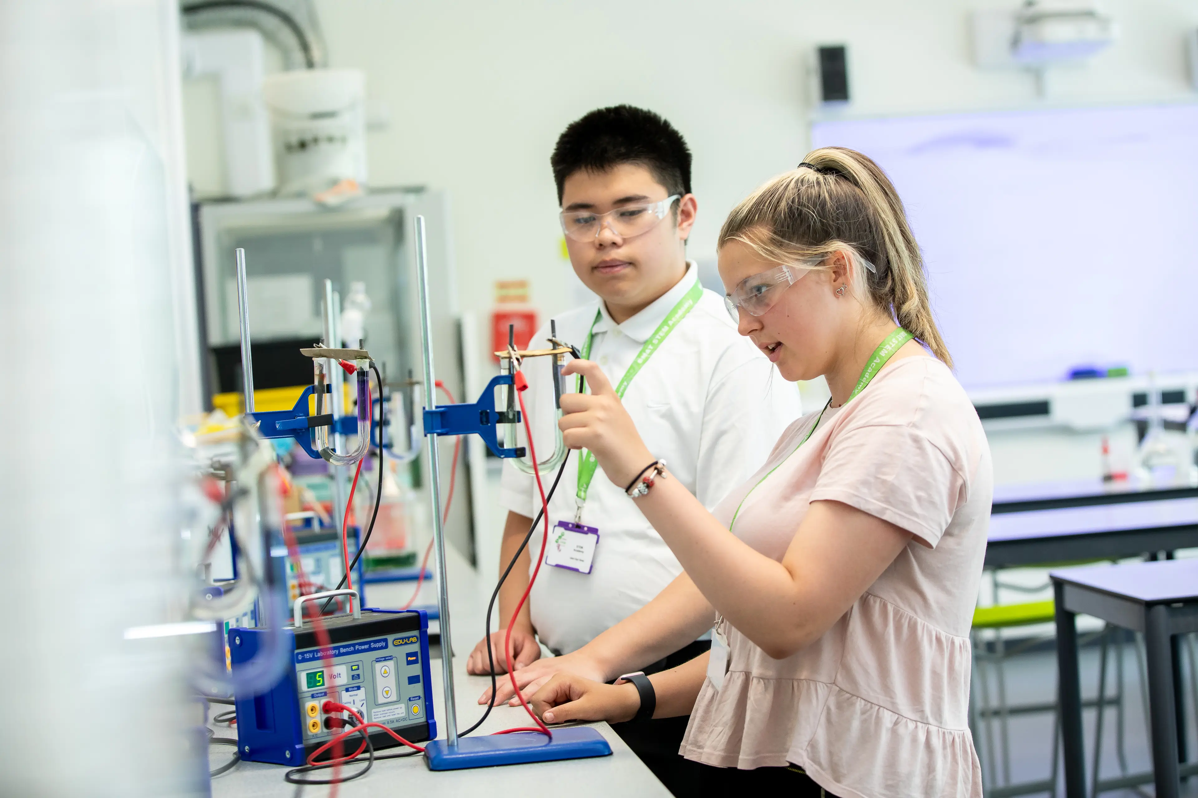 Students conducting an electrolysis experiment in a science lab